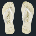 Gold Lace on Ivory Cream The Bride Elegant Wedding Thongs<br><div class="desc">Dance the night away with these beautiful wedding flip flops. Designed for the bride, they feature a simple yet elegant design with gold coloured script lettering on an ivory or cream coloured background and fancy golden lace curls and swirls. Beautiful way to stay fancy and appropriate while giving your feet...</div>