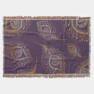 Gold peacock feather, violet background. throw blanket