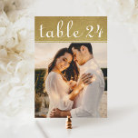 Gold Shimmer Wedding Photo Table Number Card<br><div class="desc">Warm gold shimmer texture and flowing calligraphy frame your favourite photo on this glamourous wedding table number card. The rich metallic tones and elegant script create a luxurious look for reception tables. To customise, type in the table number, click Change by the default photo to upload your own, and add...</div>