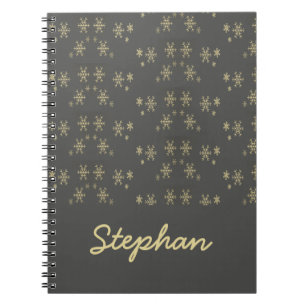 Gold snowflakes on grey notebook