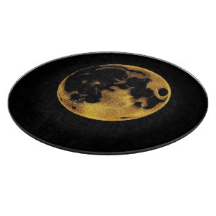 Gold textured moon on dark black cutting board