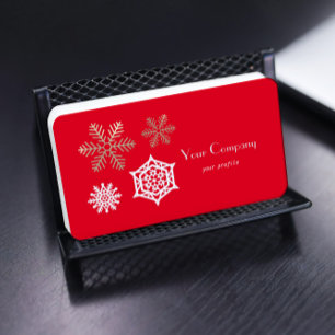 golden and white snowflakes against red business card