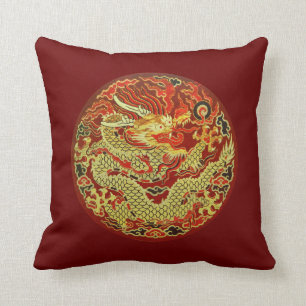 Golden asian dragon embroidered on dark red cushion