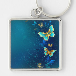 Golden Butterflies on a Blue Background Key Ring