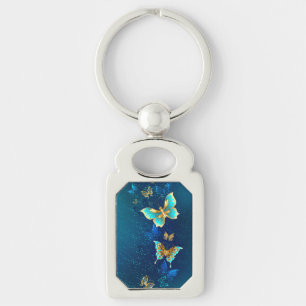 Golden Butterflies on a Blue Background Key Ring