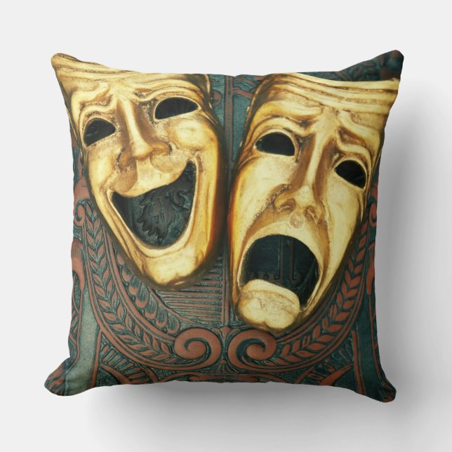 Golden comedy and tragedy masks on patterned cushion (Front)