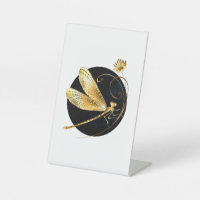 Golden dragonfly in black circle