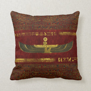 Golden Egyptian God Ornament on red leather Cushion