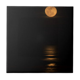golden full moon over ocean tile