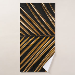 Golden painted date palm leaf closeup on abstract bath towel