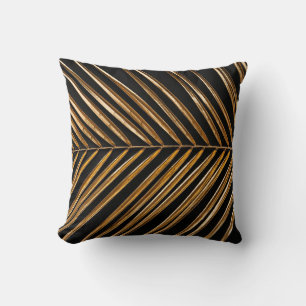 Golden painted date palm leaf closeup on abstract cushion