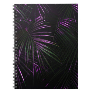 Golden painted date palm leaf closeup on dark blac notebook