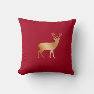 Golden reindeer silhouette on burgundy red cushion