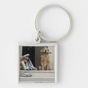 Golden retriever dog sitting at front door key ring