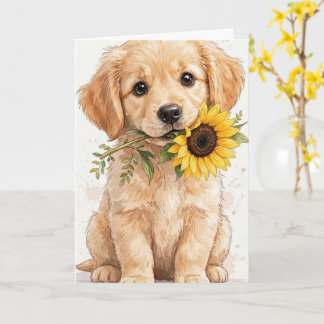Golden retriever puppy holding a sunflower card