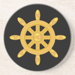 Golden ship wheel on black coaster
