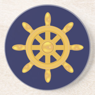 Golden ship wheel on navy blue coaster