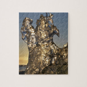 Golden sunrise seen through iceberg formation jigsaw puzzle