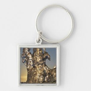 Golden sunrise seen through iceberg formation key ring