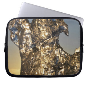 Golden sunrise seen through iceberg formation laptop sleeve