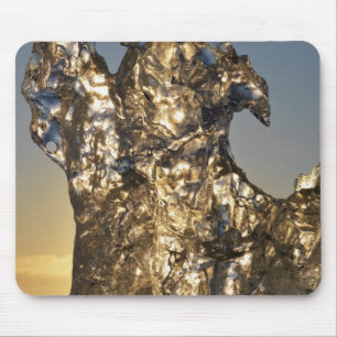 Golden sunrise seen through iceberg formation mouse pad