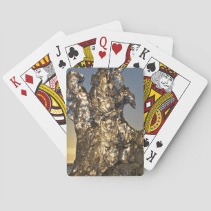 Golden sunrise seen through iceberg formation playing cards