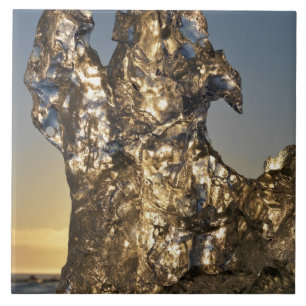 Golden sunrise seen through iceberg formation tile