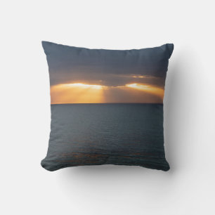 Golden sunset rays over the ocean with reflections cushion