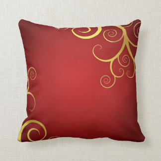 Golden swirls on deep red cushion