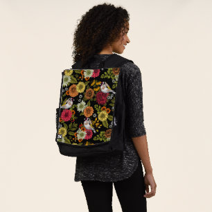 Goldfinches in the garden on black backpack