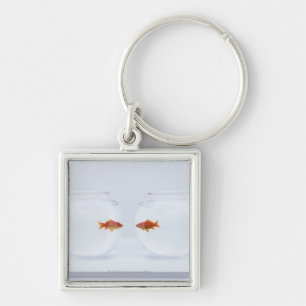 Goldfish in separate fishbowls looking face to fac key ring
