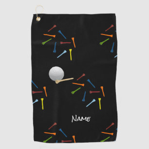 Golf ball and colourful tees on black background towel