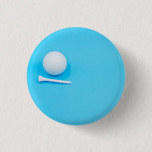 Golf ball and tee are on blue background 3 cm round badge