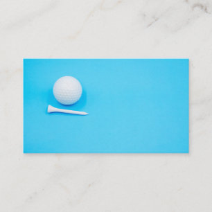Golf ball and tee on blue background business card