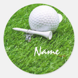 Golf ball and tee on green grass classic round sticker