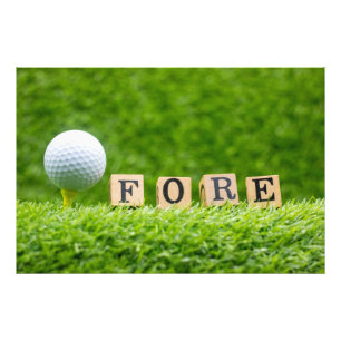 Golf ball is on tee with green grass background photo print