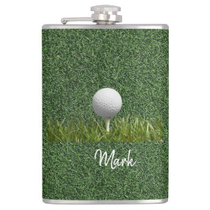 Golf ball on green grass hip flask