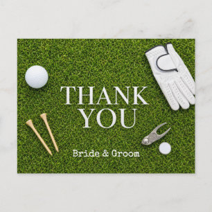 Golf ball on green grass postcard