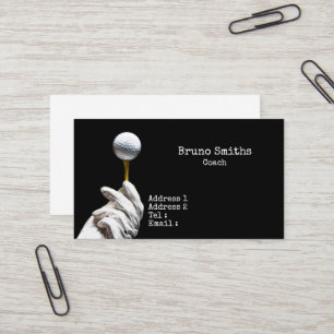 Golf  ball on pin next to hole black background  business card