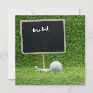 Golf ball with blank chalkboard on green grass