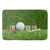 Golf ball with LOVE word and tee on green grass