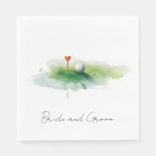 Golf ball with red heart tee on green grass napkin