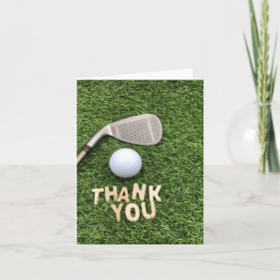 Golf ball with thank you word on green grass  note card