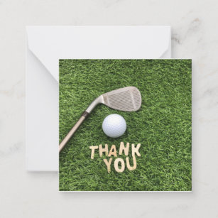 Golf ball with thank you word on green grass  note card