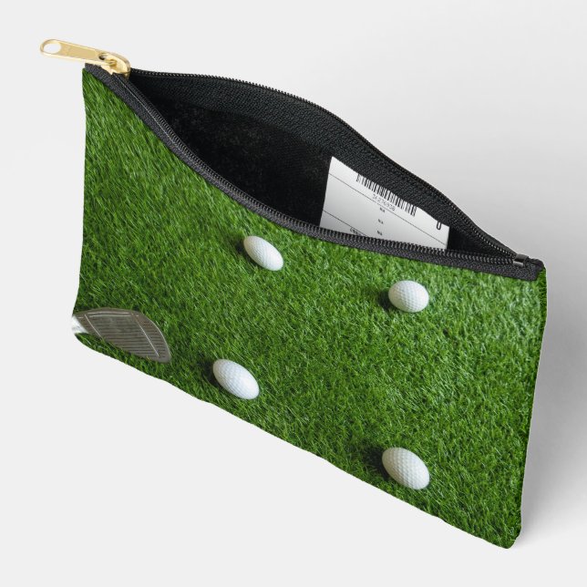 Golf balls are on green grass accessory pouch (Open)