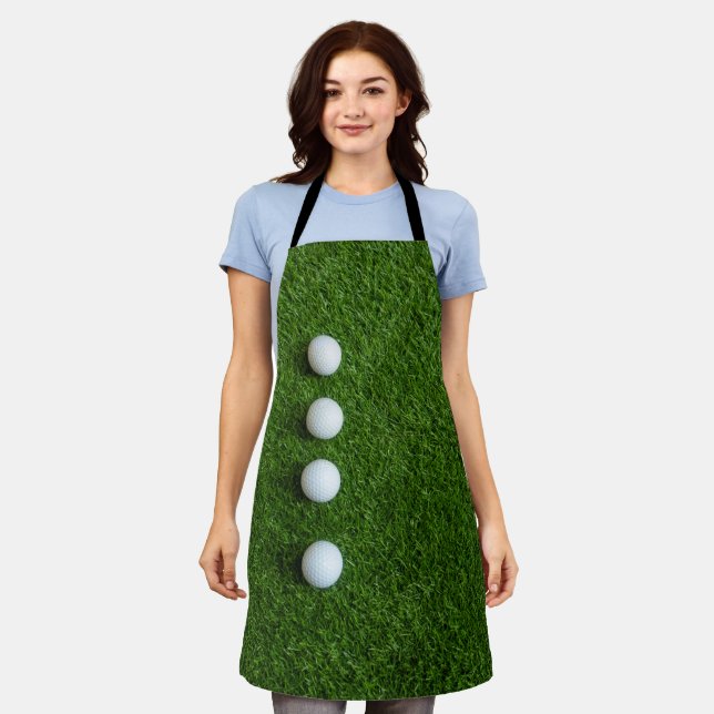 Golf Balls are on green grass Apron (Worn)
