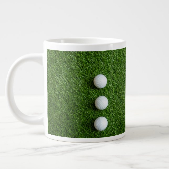 Golf Balls are on green grass Large Coffee Mug (Left)