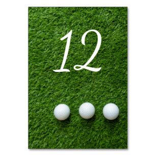 Golf balls are on green grass table number
