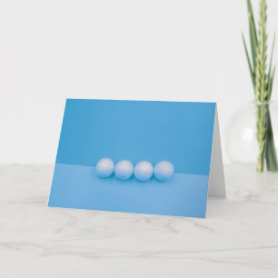 Golf balls on blue background card