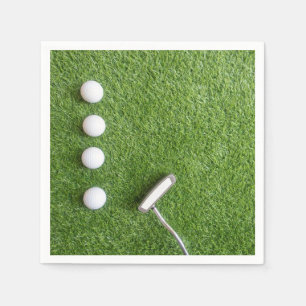 Golf balls with putter on green grass for golfer napkin